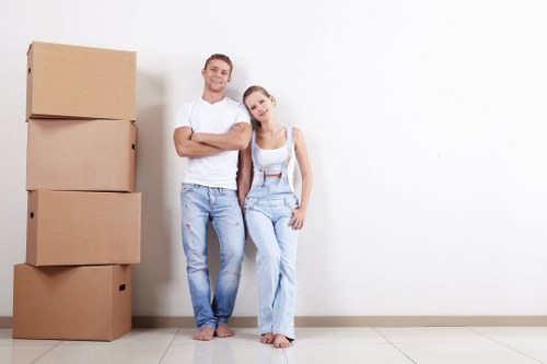 Removal team handling a flat move in Hounslow with boxes and furniture